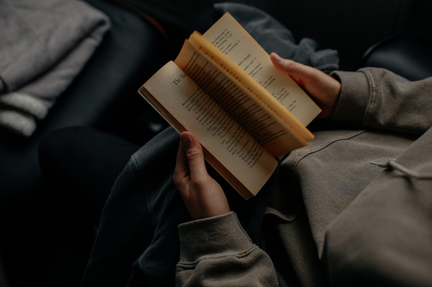 Open book and writing hands